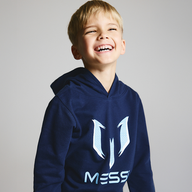 A child wearing a navy hoodie with a Messi logo design. banner