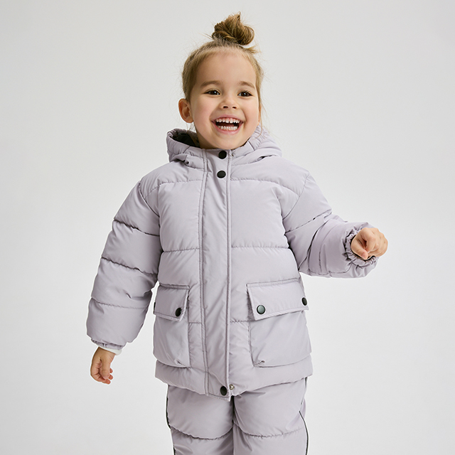 A person is wearing a white hoodie with a teddy bear graphic surrounded by stars and a heart. Paired with black pants featuring heart and stripe designs. Casual outfit suitable for everyday wear or lounging. Image emphasizes clothing details and design features. banner